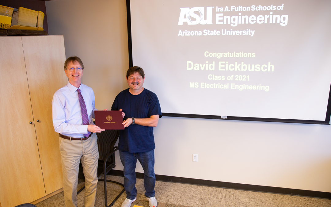 David Eickbusch receives his degree from Dean Kyle Squires