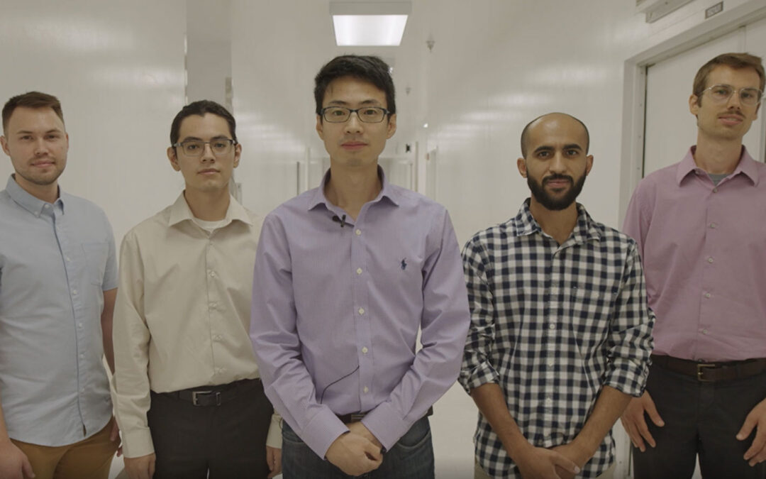 Five members of the Beyond Silicon team pose in a bright hallway
