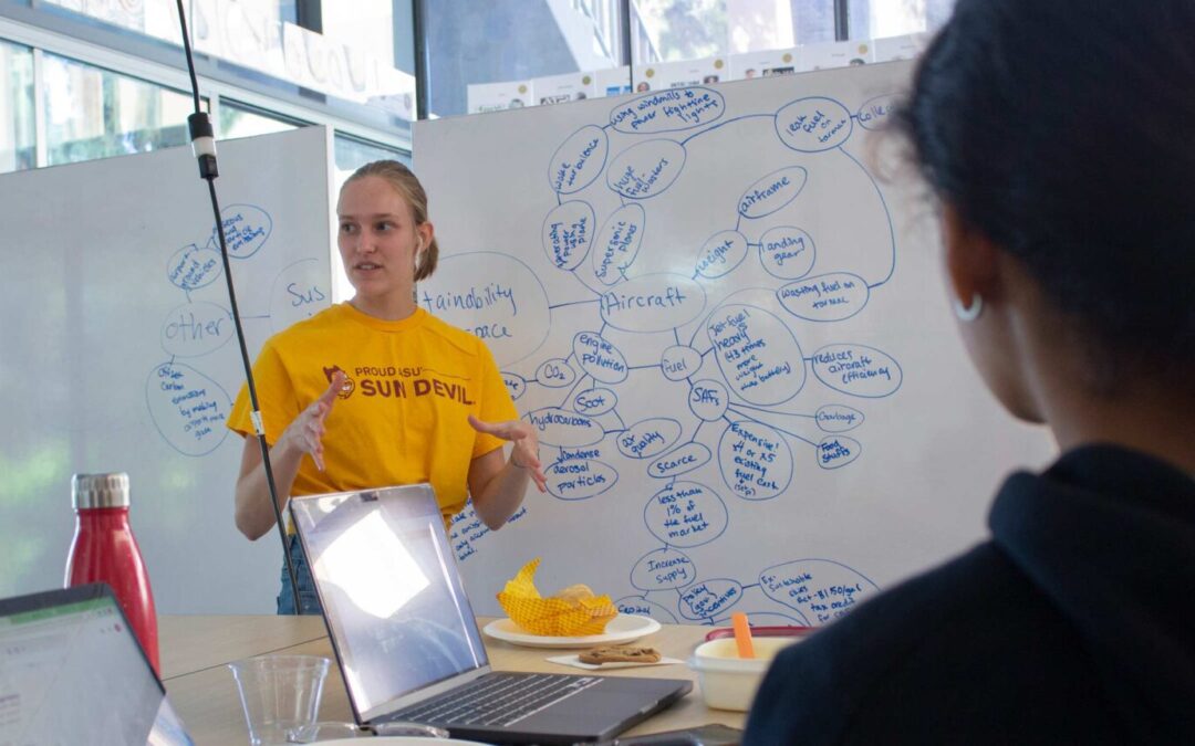 Sydney Lenski speaking to her teammates at Devils Invent: Aerospace Sustainability