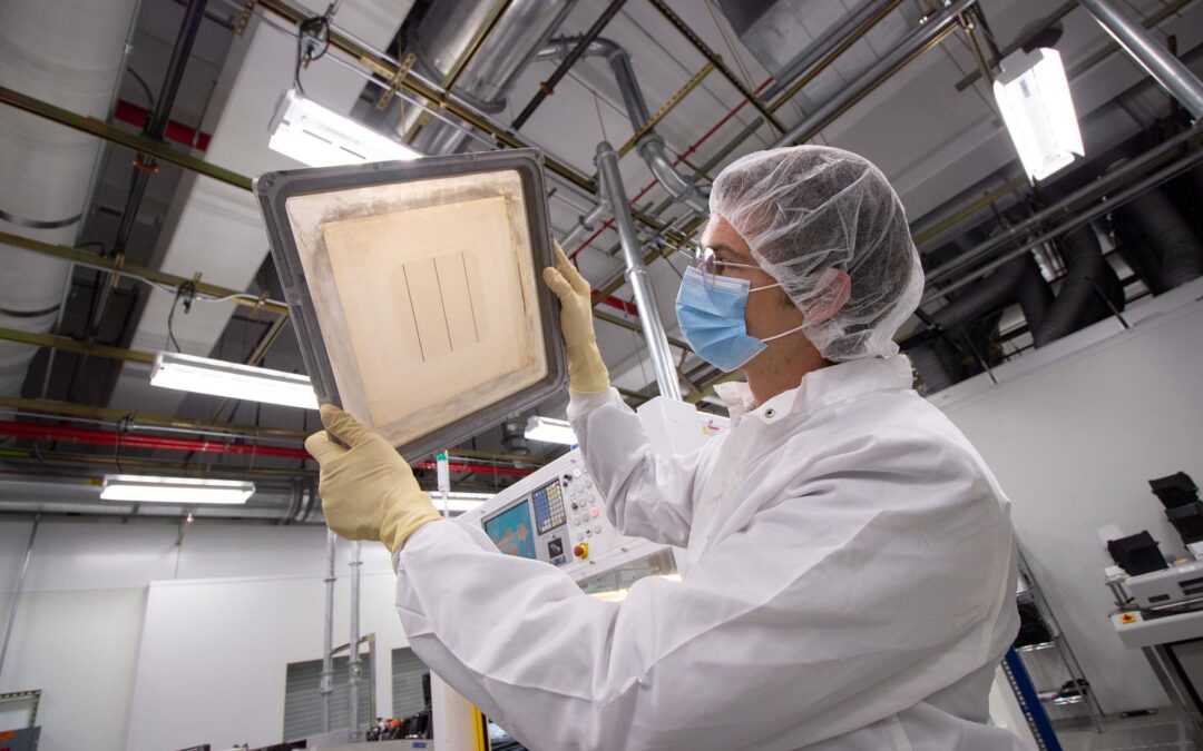 A researcher examines semiconductor material in MacroTechnology Works