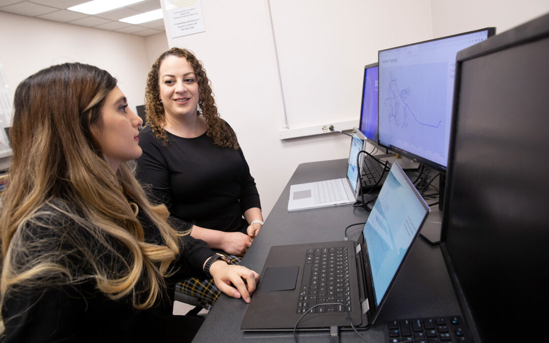 Electrical engineering doctoral student Zahra Soltani and Assistant Professor of electrical engineering Mojdeh Khorsand Hedman operate a computer program to monitor power grid status.