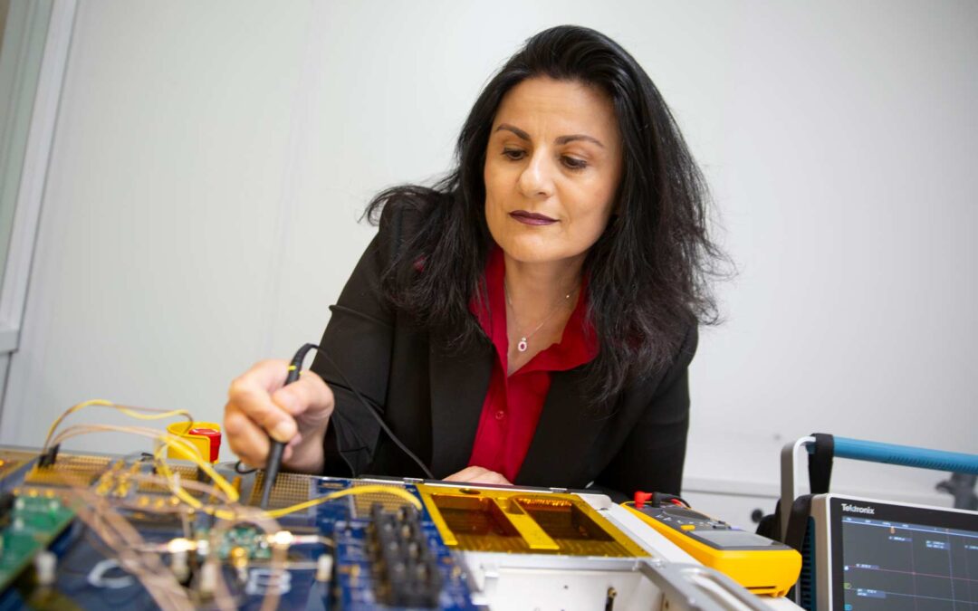 Sule Ozev uses electrical testing equipment to ensure proper operation of an electronic device