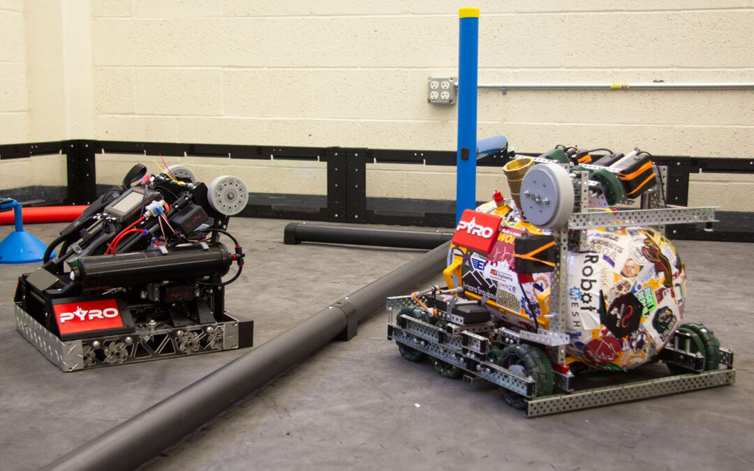 Two robots from Arizona State University’s Rossum Rumblers VEX Robotics competition team, PYRO, sit in the team’s practice arena on ASU’s Polytechnic campus