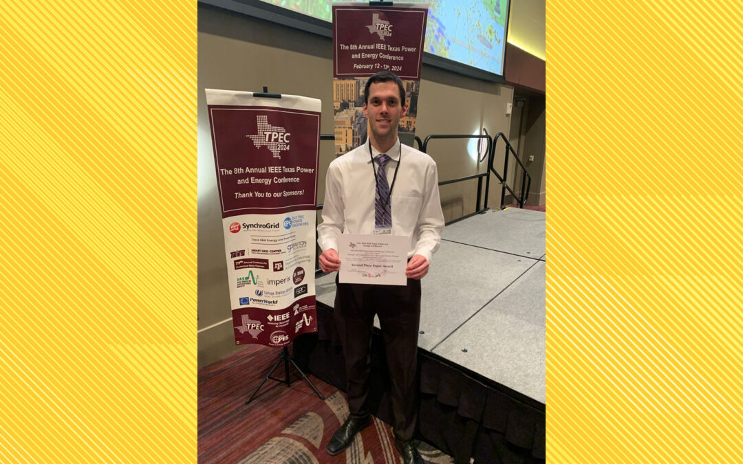Zachary Lythgoe holding his second best paper award from IEEE TPEC