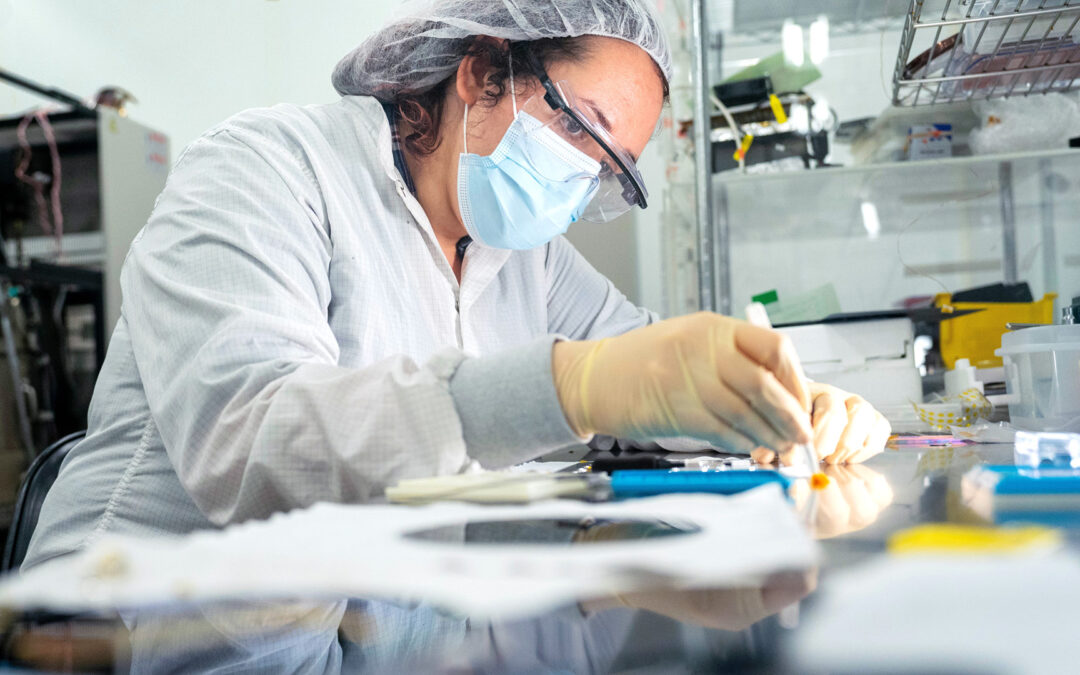 A researcher works with semiconductor material at MacroTechnology Works