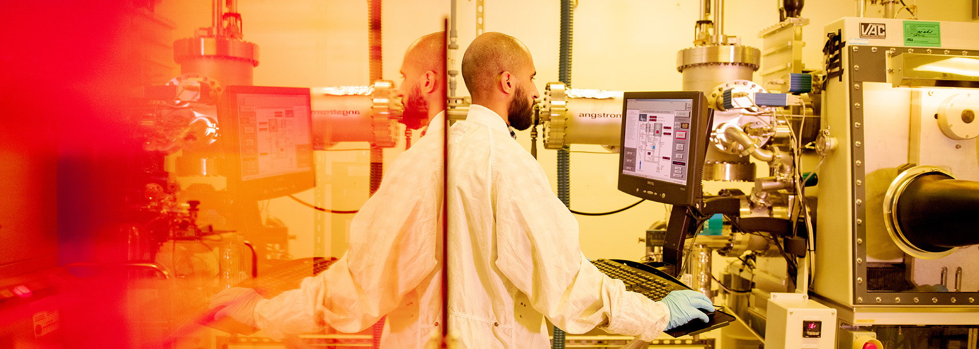 A man works on a computer in a lab