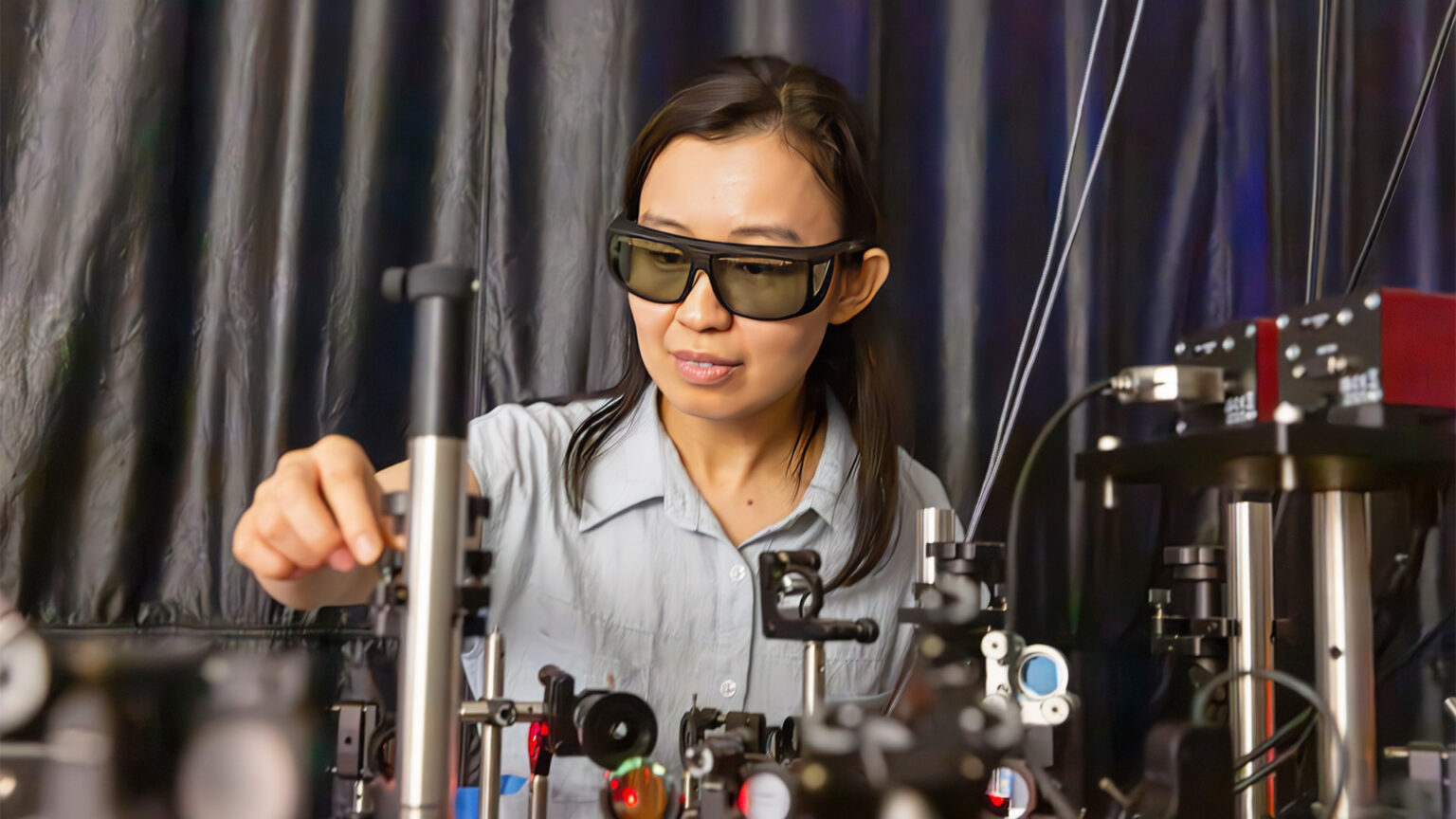 Professor wearing protective glasses working with sensors and equipment